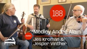 Two fiddler and a piano accordionist preparing to play a tune in a living room