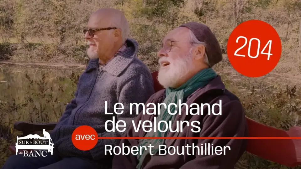 Deux hommes chantent sur un banc rouge en automne