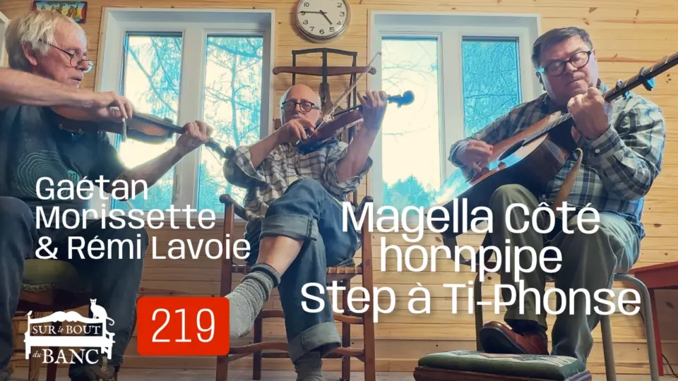 Trois hommes jouent violons et guitare dans une entrée de maison à l'automne